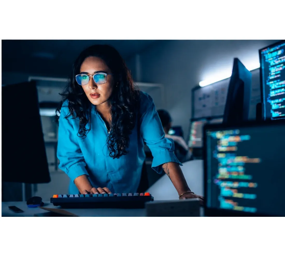 Developer writing Laravel application code across multiple monitors