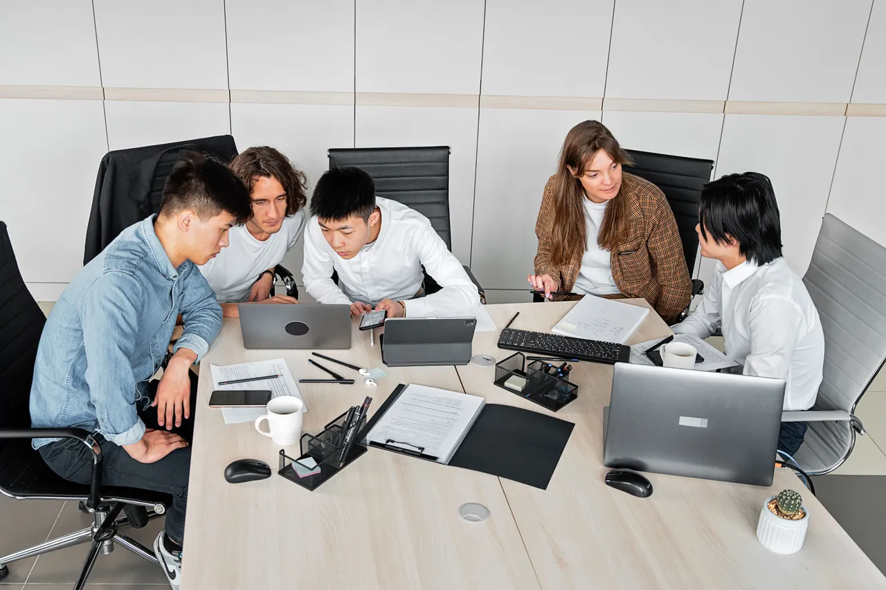 Team comparing hosting plans together around a meeting table